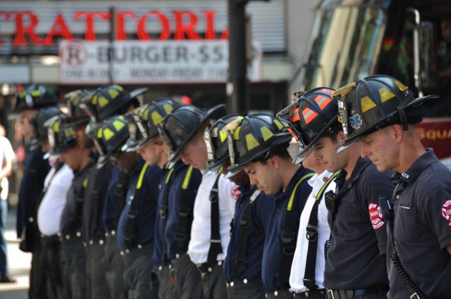September 11, 2011 Firefighters lower their head in a moment of silence